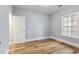 Bedroom featuring wood flooring, neutral walls, and a bright window at 118 Birch N Coppice Dr. # 2, Surfside Beach, SC 29575