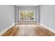Spacious bedroom with a large window and hardwood flooring providing natural light and ample space at 118 Birch N Coppice Dr. # 2, Surfside Beach, SC 29575
