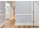 Bright hallway with wood floors leading to bathroom and other rooms at 118 Birch N Coppice Dr. # 2, Surfside Beach, SC 29575