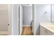 Hallway view of a bathroom featuring wood flooring and neutral wall colors at 118 Birch N Coppice Dr. # 2, Surfside Beach, SC 29575