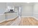Open-concept living and kitchen area with wood flooring and modern lighting at 118 Birch N Coppice Dr. # 2, Surfside Beach, SC 29575