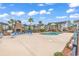 Community pool area with lounge chairs, outdoor fireplace and condominium buildings in the background at 118 Birch N Coppice Dr. # 2, Surfside Beach, SC 29575