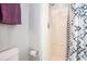 Simple bathroom with a toilet and shower featuring a white shower stall and black and white shower curtain at 1205 Erin Way # 5C, Myrtle Beach, SC 29577