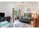 Airy bedroom featuring a bamboo headboard, desk, a balcony, and a ceiling fan at 1205 Erin Way # 5C, Myrtle Beach, SC 29577