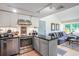 Stylish kitchen showcasing stainless steel appliances, white cabinets, black countertops, and open to the living space at 1205 Erin Way # 5C, Myrtle Beach, SC 29577