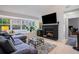 Cozy living room with a decorative fireplace, a large window, and a comfortable gray sectional sofa at 1205 Erin Way # 5C, Myrtle Beach, SC 29577