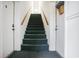 Carpeted stairway with white walls and doors, and wood banister at 1205 Erin Way # 5C, Myrtle Beach, SC 29577