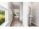 Bright hallway featuring hardwood floors and natural light from a nearby window at 125 Dagger Ct., Myrtle Beach, SC 29588