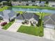Aerial view shows the home's placement, landscaping, driveway, garage, and proximity to the community pond at 131 River Country Dr., Conway, SC 29526