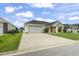 Charming single-story home with a two-car garage and well-manicured landscaping on a sunny day at 131 River Country Dr., Conway, SC 29526