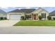 Charming single-story home featuring an attached two-car garage, well-manicured lawn, and inviting front porch at 131 River Country Dr., Conway, SC 29526