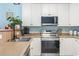 Bright kitchen features stainless steel appliances, neutral countertops, and white cabinetry at 131 River Country Dr., Conway, SC 29526