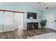 Cozy living room featuring modern decor, a mounted TV, and a barn door leading to another room at 131 River Country Dr., Conway, SC 29526
