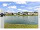 View of a community pond with a fountain and a serene backdrop of well-maintained homes at 131 River Country Dr., Conway, SC 29526