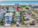 Aerial view of a charming two-story home near the beach, showcasing its architecture and proximity to the ocean at 1473 Basin Trail, Murrells Inlet, SC 29576