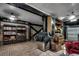 Finished basement features dark beams, exposed ductwork, and brick floors, creating a rustic and versatile space at 1473 Basin Trail, Murrells Inlet, SC 29576