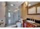 This bathroom has a marble shower with glass door, tiled floors, an ornate vanity, and modern fixtures at 1473 Basin Trail, Murrells Inlet, SC 29576