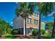 The exterior features a multi-story building with a neutral color scheme, surrounded by lush landscaping and palm trees at 1473 Basin Trail, Murrells Inlet, SC 29576