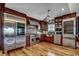 Well-appointed kitchen featuring high-end appliances, custom cabinetry, brick accents, and ample counter space at 1473 Basin Trail, Murrells Inlet, SC 29576