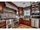 Gourmet kitchen with stainless steel appliances, brick backsplash, custom cabinets, and a chef-grade range at 1473 Basin Trail, Murrells Inlet, SC 29576