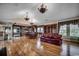 Open-concept living area features hardwood floors, custom built-ins, and great natural light from multiple windows at 1473 Basin Trail, Murrells Inlet, SC 29576