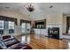 Spacious living room with vaulted ceilings, a fireplace, hardwood floors, and access to the outdoor seating at 1473 Basin Trail, Murrells Inlet, SC 29576