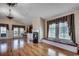 Inviting living room showcasing hardwood floors, a fireplace, a window seat, and access to outdoor spaces at 1473 Basin Trail, Murrells Inlet, SC 29576