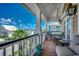 This outdoor porch offers seating, a ceiling fan, light fixtures, and distant views of the surrounding neighborhood at 1473 Basin Trail, Murrells Inlet, SC 29576