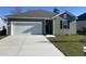 Charming single-story home featuring a one-car garage, manicured lawn, and traditional siding in a neutral color palette at 156 Dagger Ct., Myrtle Beach, SC 29588