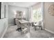 Serene home office featuring a gray desk, chair, and ample natural light from a large window at 1664 Hope Pointe Dr, North Myrtle Beach, SC 29582