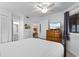 This bedroom has light colored walls, a ceiling fan, and a beach scene on the television at 180 Rothbury Circle # 305, Myrtle Beach, SC 29572