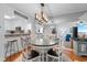 Elegant dining area boasts a glass-top table, seating for four, and chic lighting fixtures, perfect for entertaining at 180 Rothbury Circle # 305, Myrtle Beach, SC 29572