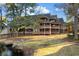 Multi-level condo featuring wood balconies and lush landscaping near the water at 180 Rothbury Circle # 305, Myrtle Beach, SC 29572