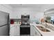 Modern kitchen boasting stainless steel appliances and beautiful tile backsplash at 180 Rothbury Circle # 305, Myrtle Beach, SC 29572