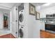 A compact laundry area equipped with stacked washer and dryer in the unit at 180 Rothbury Circle # 305, Myrtle Beach, SC 29572
