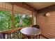 A charming outdoor patio with table and chairs offers a green, wooded view at 180 Rothbury Circle # 305, Myrtle Beach, SC 29572