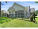 This lovely backyard features a screened-in porch, an iron fence, and lush grass at 183 Glenwood Dr., Conway, SC 29526