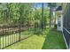 The backyard features a well-manicured lawn, an iron fence, and pond access at 183 Glenwood Dr., Conway, SC 29526