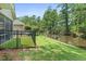 This backyard features a well-manicured lawn, a pond, an iron fence, and mature trees at 183 Glenwood Dr., Conway, SC 29526