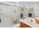 Bright bathroom featuring a shower with glass doors and a vanity with neutral countertops and wood cabinets at 183 Glenwood Dr., Conway, SC 29526