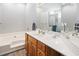 Bright bathroom featuring dual sink vanity, large mirror, and combination tub and shower at 183 Glenwood Dr., Conway, SC 29526