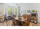 Bright dining area with large windows and a wood table, adjacent to a home office at 183 Glenwood Dr., Conway, SC 29526