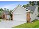 Lovely home with a two car garage, well-manicured lawn, gray siding, brick accents, and a concrete driveway at 183 Glenwood Dr., Conway, SC 29526