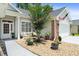 Beautiful home exterior with an inviting front porch, rocking chairs, gravel landscaping, and an American flag at 183 Glenwood Dr., Conway, SC 29526