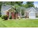 Beautifully landscaped home with a well-manicured lawn, gray siding, red shutters and a two car garage at 183 Glenwood Dr., Conway, SC 29526