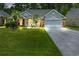 Charming home with a well-manicured lawn, gray siding, brick accents, and a two car garage at 183 Glenwood Dr., Conway, SC 29526