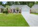 Charming home with a well-manicured lawn, gray siding, brick accents, and a two car garage at 183 Glenwood Dr., Conway, SC 29526