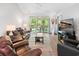 Comfortable living room with a leather sofa and sliding glass doors to the outdoor patio at 183 Glenwood Dr., Conway, SC 29526