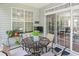 Cozy covered patio with an outdoor table, seating, and large windows, perfect for relaxing and entertaining at 183 Glenwood Dr., Conway, SC 29526