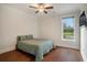 Relaxing bedroom with a ceiling fan, hardwood floors, view of trees and a comfy bed at 1844 Wood Stork Dr., Conway, SC 29526